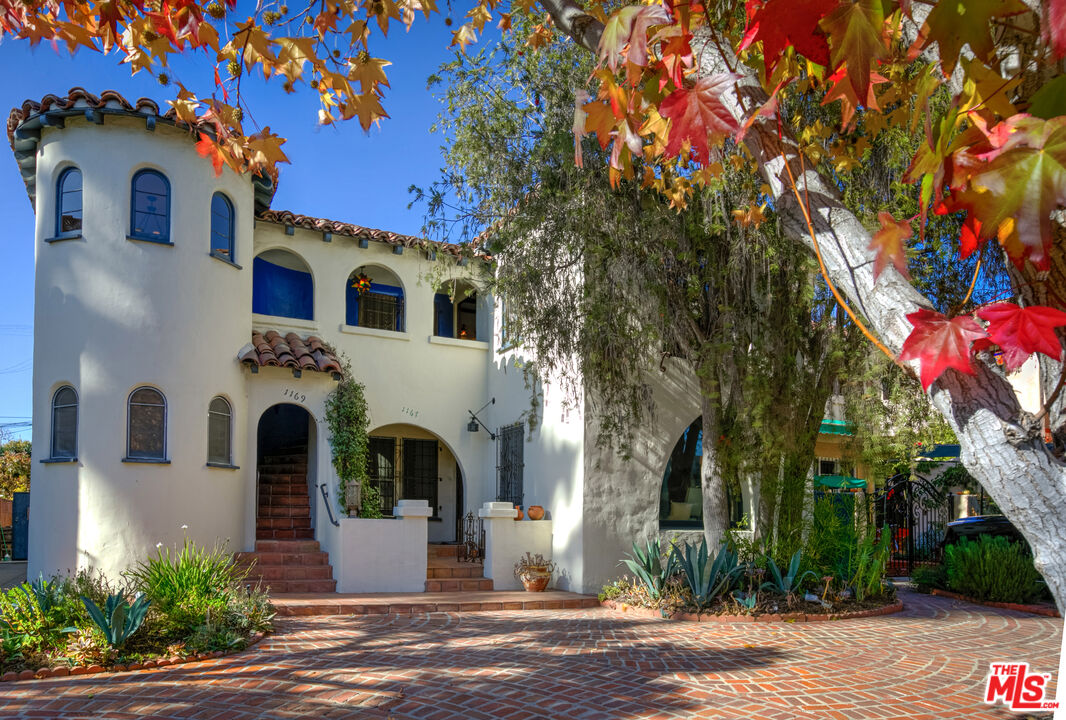 1169 Hi Point Street Los Angeles, CA 90035 - Photo 1 of 27 a front view of a house with yard
