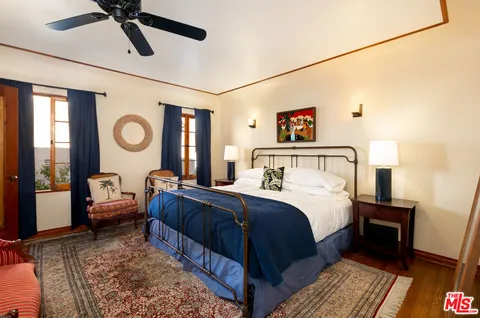 a bedroom with a bed couch and a window