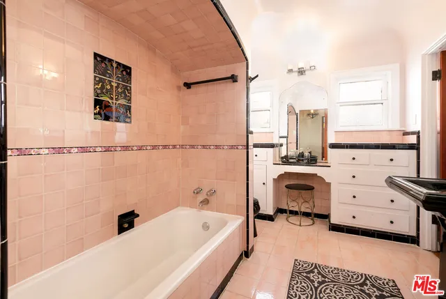 a bathroom with a tub sink and a window