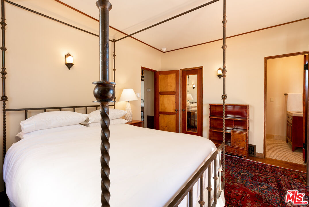 1169 Hi Point Street Los Angeles, CA 90035 - Photo 11 of 27 a bed sitting in a bedroom next to a window