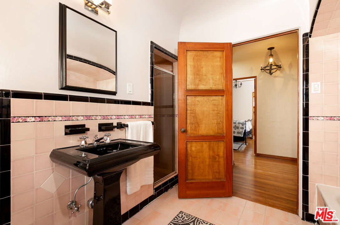 1169 Hi Point Street Los Angeles, CA 90035 - Photo 21 of 27 a bathroom with a sink and a mirror