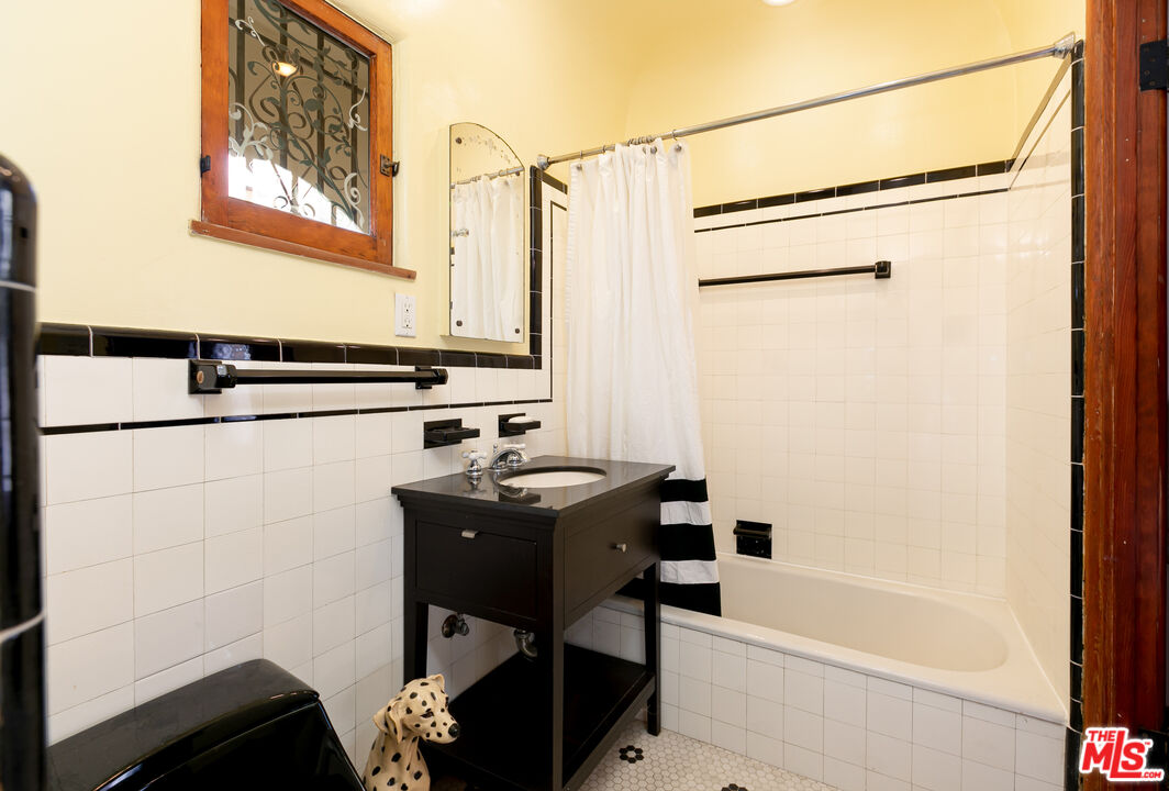 1169 Hi Point Street Los Angeles, CA 90035 - Photo 26 of 27 a bathroom with a sink and a bathtub