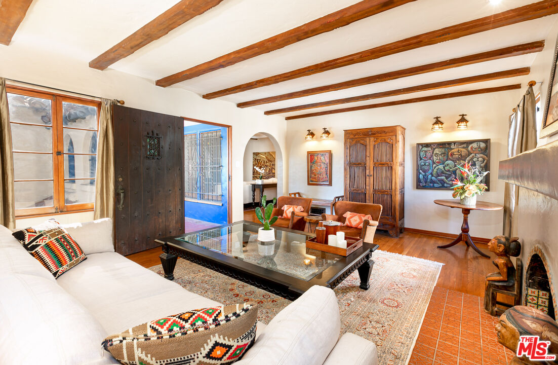 1169 Hi Point Street Los Angeles, CA 90035 - Photo 3 of 27 a living room with furniture and a floor to ceiling window