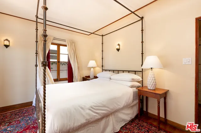 a bedroom with a bed and a table