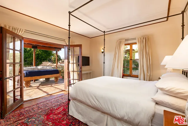 a bedroom with a bed window and a table