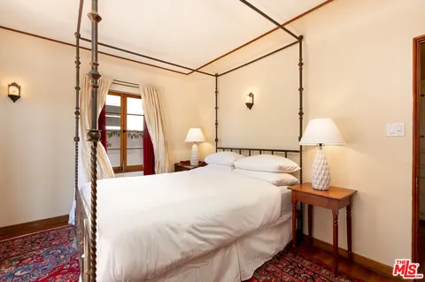 a bedroom with a bed and a table