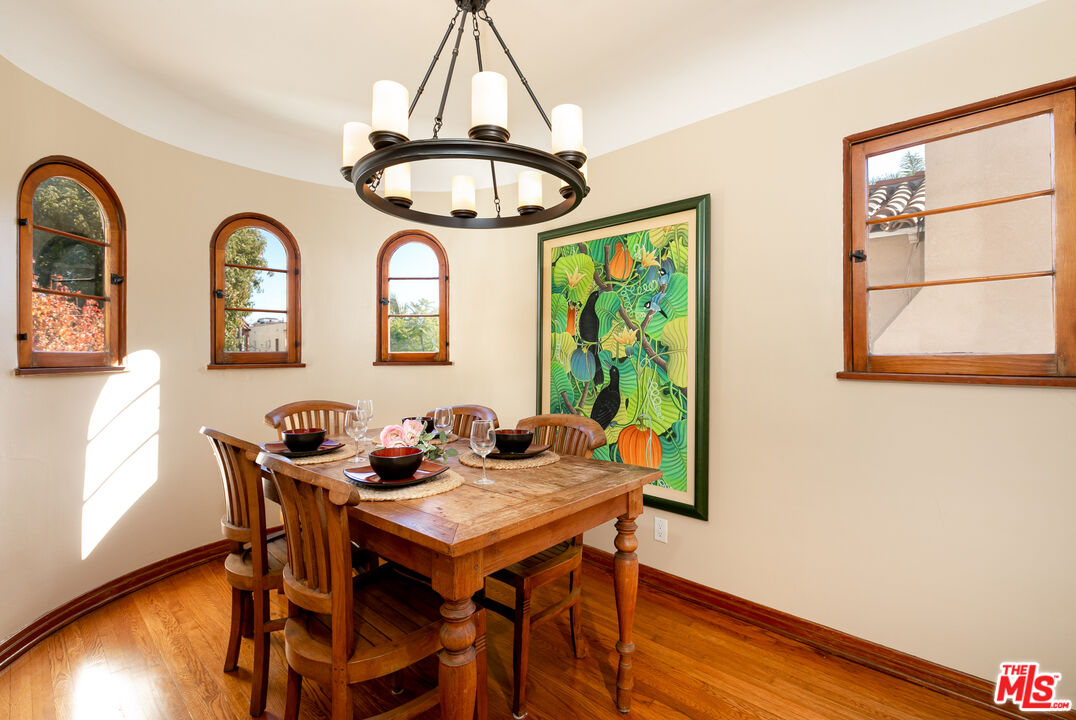 1169 Hi Point Street Los Angeles, CA 90035 - Photo 8 of 27 a dining room with furniture a window and wooden floor