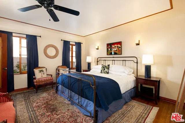 a bedroom with a bed couch and a window