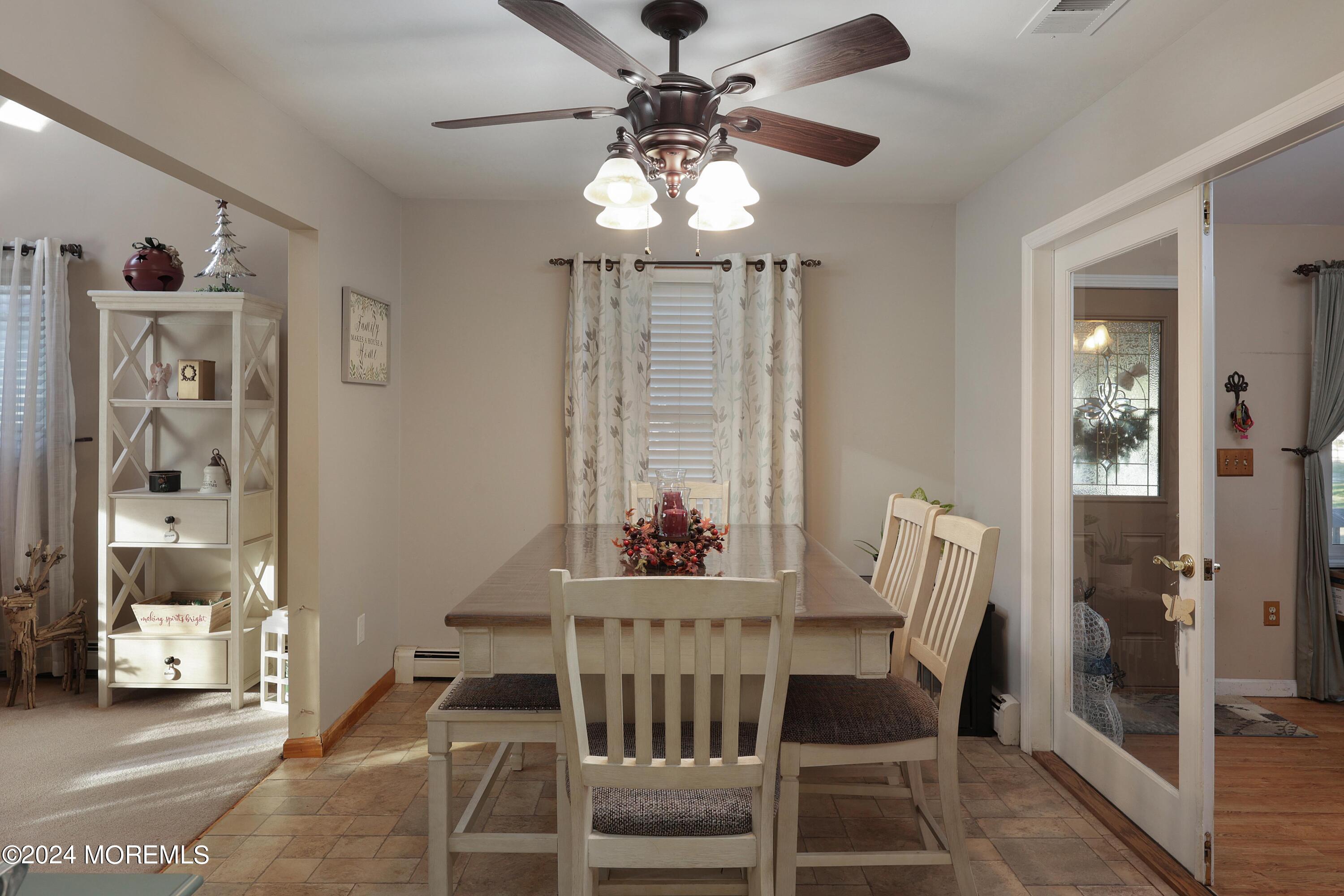 1058 Maxim Southard Road Howell, NJ 07731 - Photo 8 of 34 a view of a dining room with furniture wooden floor and chandelier
