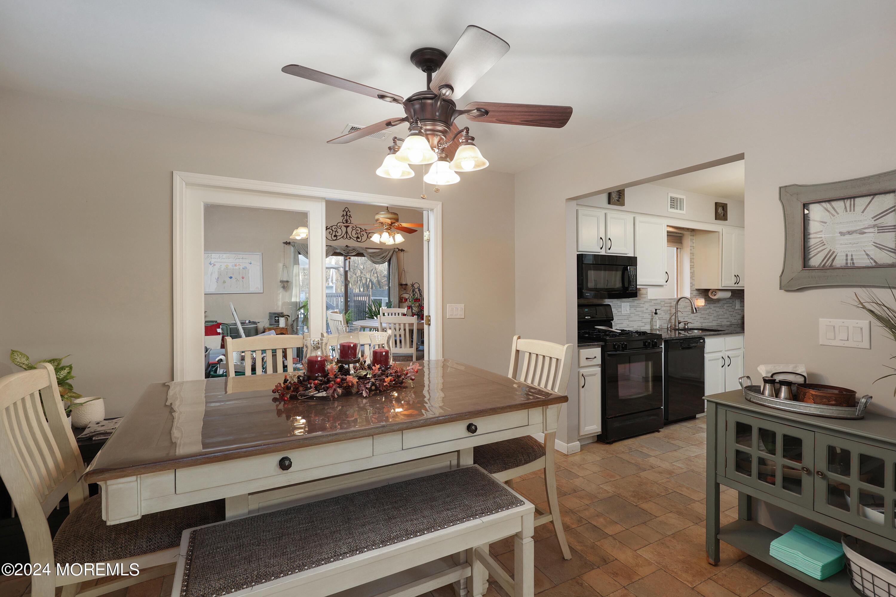 1058 Maxim Southard Road Howell, NJ 07731 - Photo 9 of 34 a kitchen with stainless steel appliances kitchen island granite countertop a stove and a sink