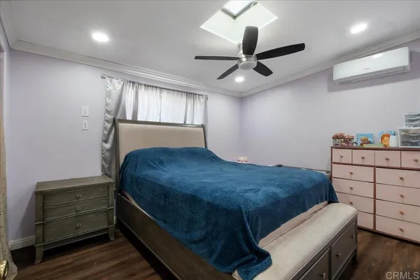 a bed room with a bed and a ceiling fan