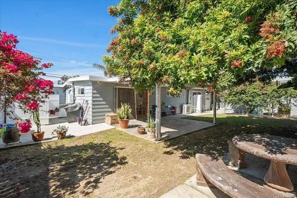 a wooden bench sitting in front of a house