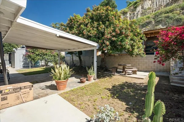 a view of a backyard with sitting area