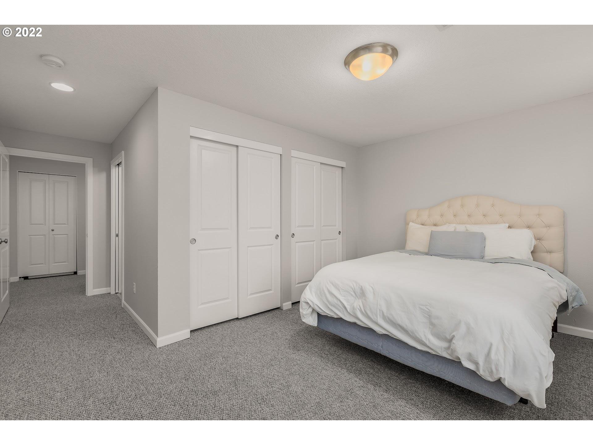 16695 Southwest Baseline Road Beaverton, OR 97006 - Photo 12 of 19 a bedroom with a bed and a cabinets