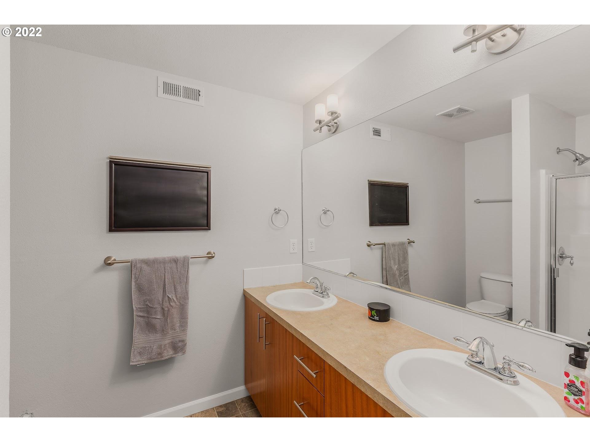 16695 Southwest Baseline Road Beaverton, OR 97006 - Photo 16 of 19 a bathroom with a sink double vanity and mirror