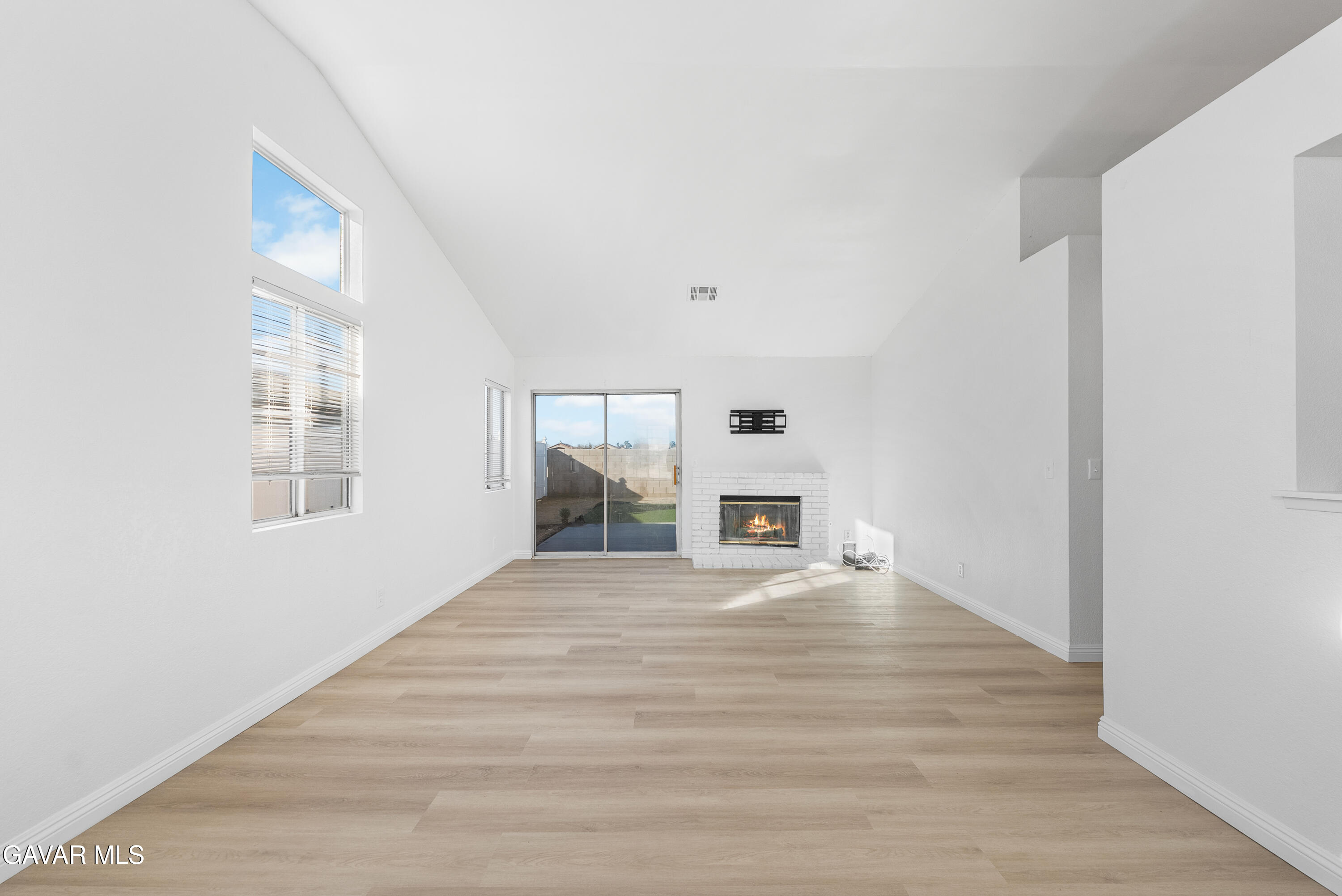 3209 Titcher Lane Rosamond, CA 93560 - Photo 12 of 36 a view of a hallway with wooden floor and a living room