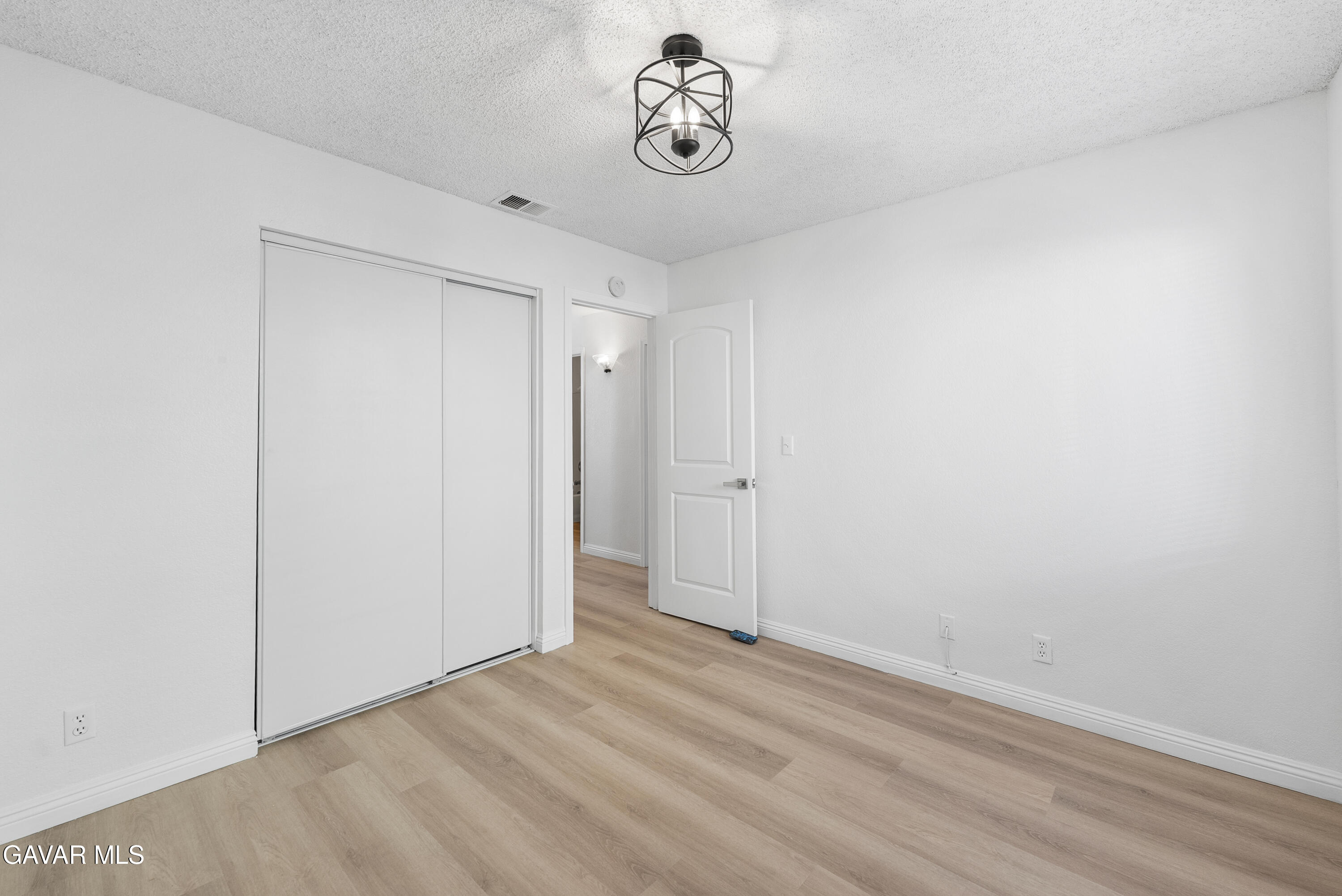 3209 Titcher Lane Rosamond, CA 93560 - Photo 19 of 36 a view of a room with wooden floor