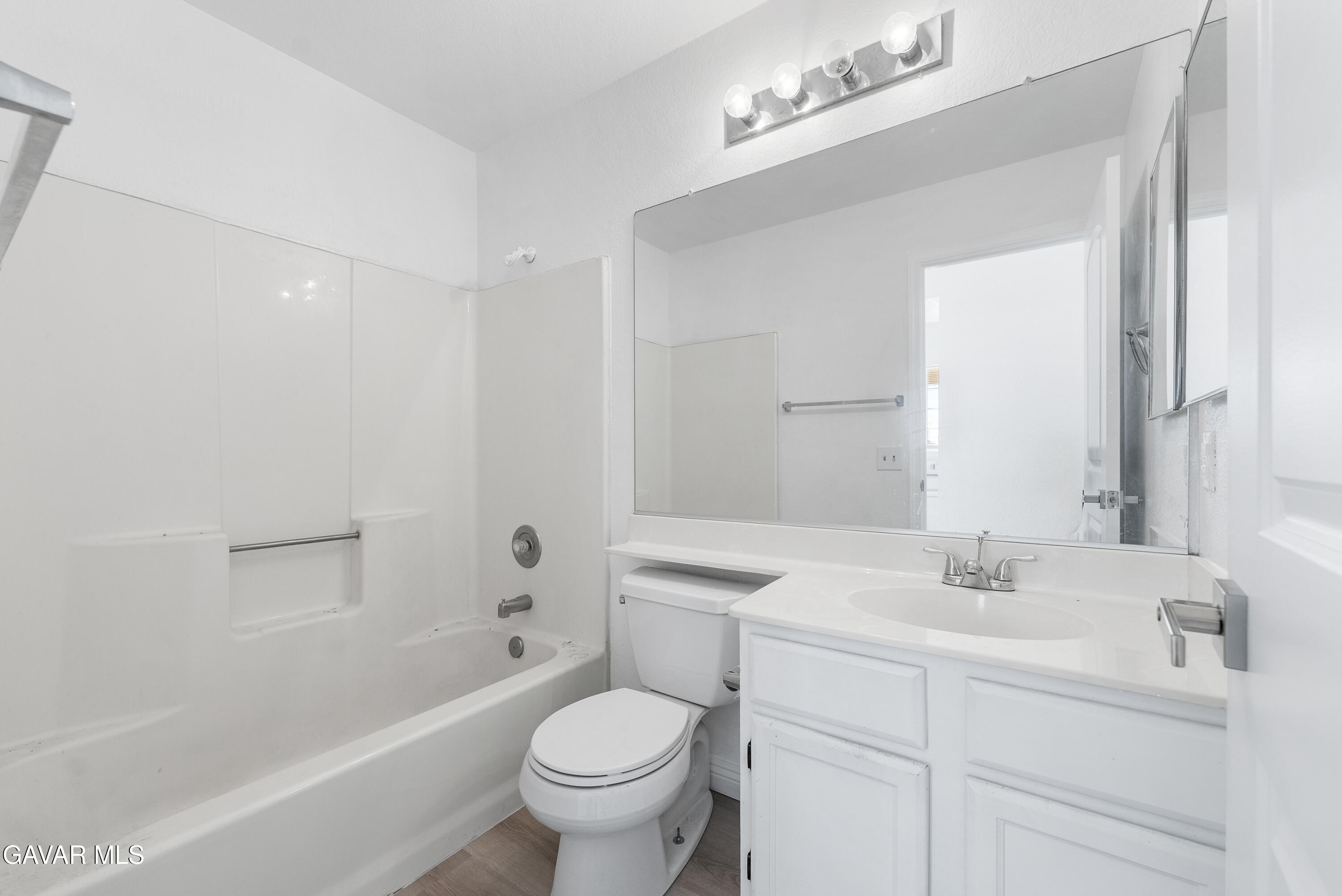 3209 Titcher Lane Rosamond, CA 93560 - Photo 20 of 36 a bathroom with a sink toilet a mirror and shower