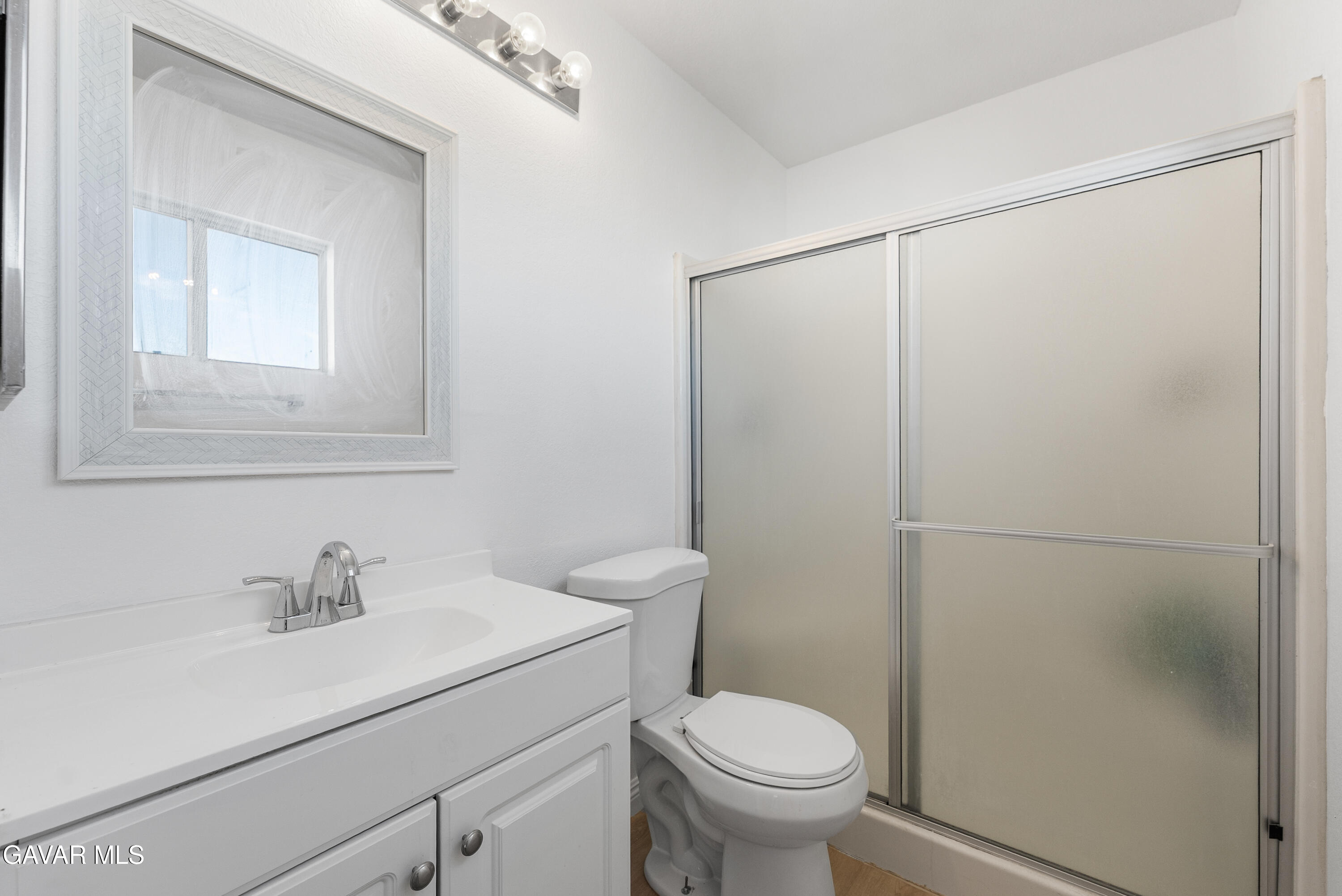 3209 Titcher Lane Rosamond, CA 93560 - Photo 26 of 36 a bathroom with a sink toilet and vanity