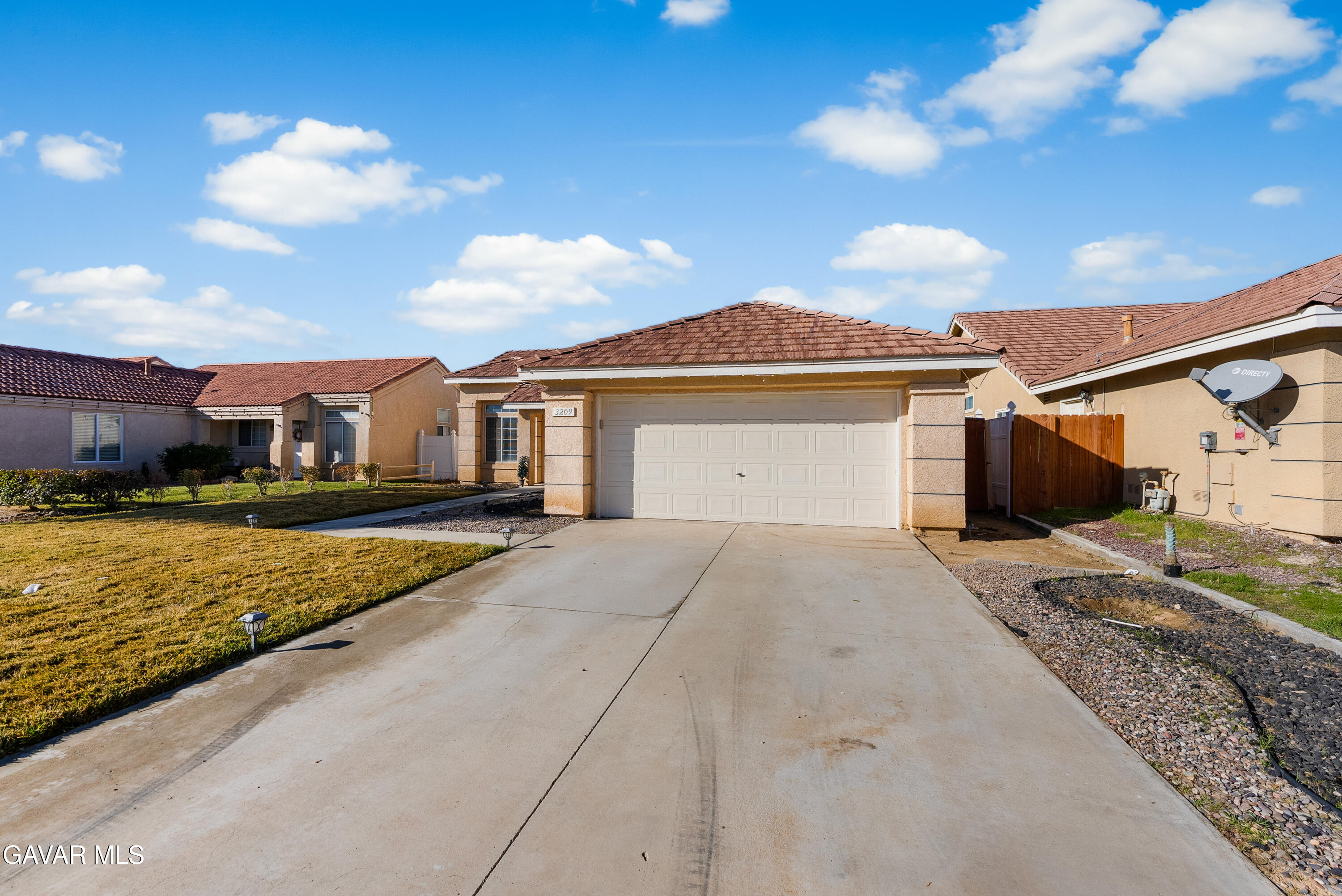 3209 Titcher Lane Rosamond, CA 93560 - Photo 28 of 36 a front view of a house with garden