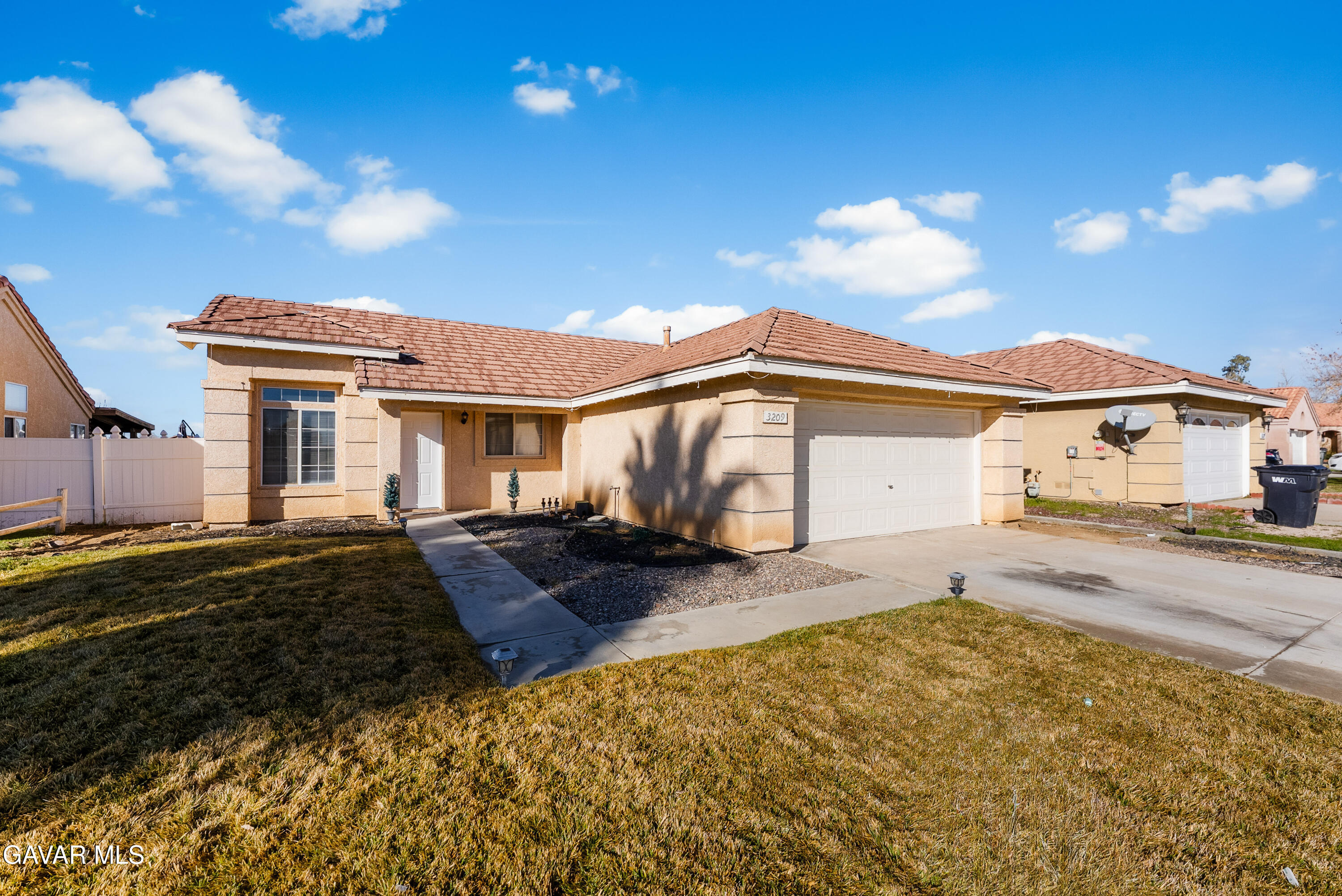 3209 Titcher Lane Rosamond, CA 93560 - Photo 29 of 36 a front view of a house with a yard