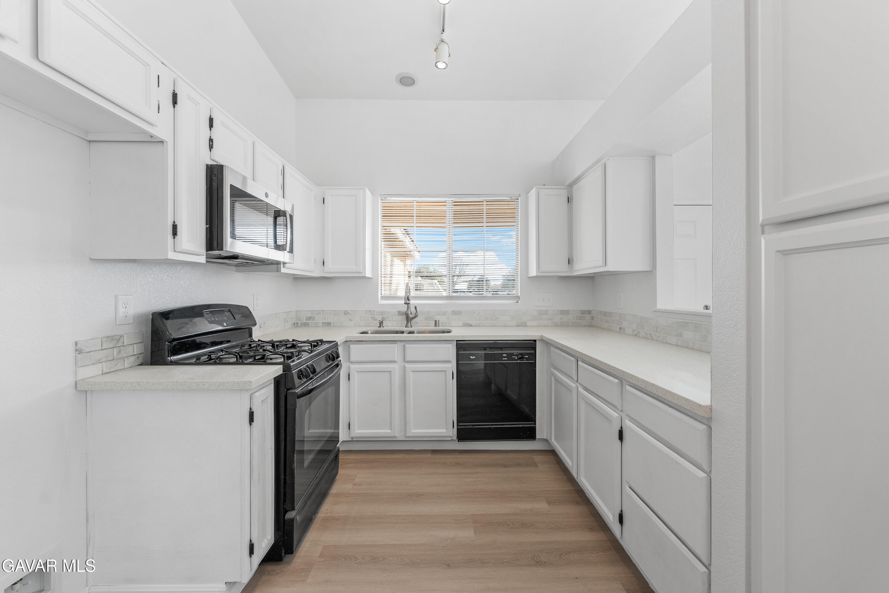 3209 Titcher Lane Rosamond, CA 93560 - Photo 6 of 36 a kitchen with stainless steel appliances granite countertop a stove a sink dishwasher and a refrigerator