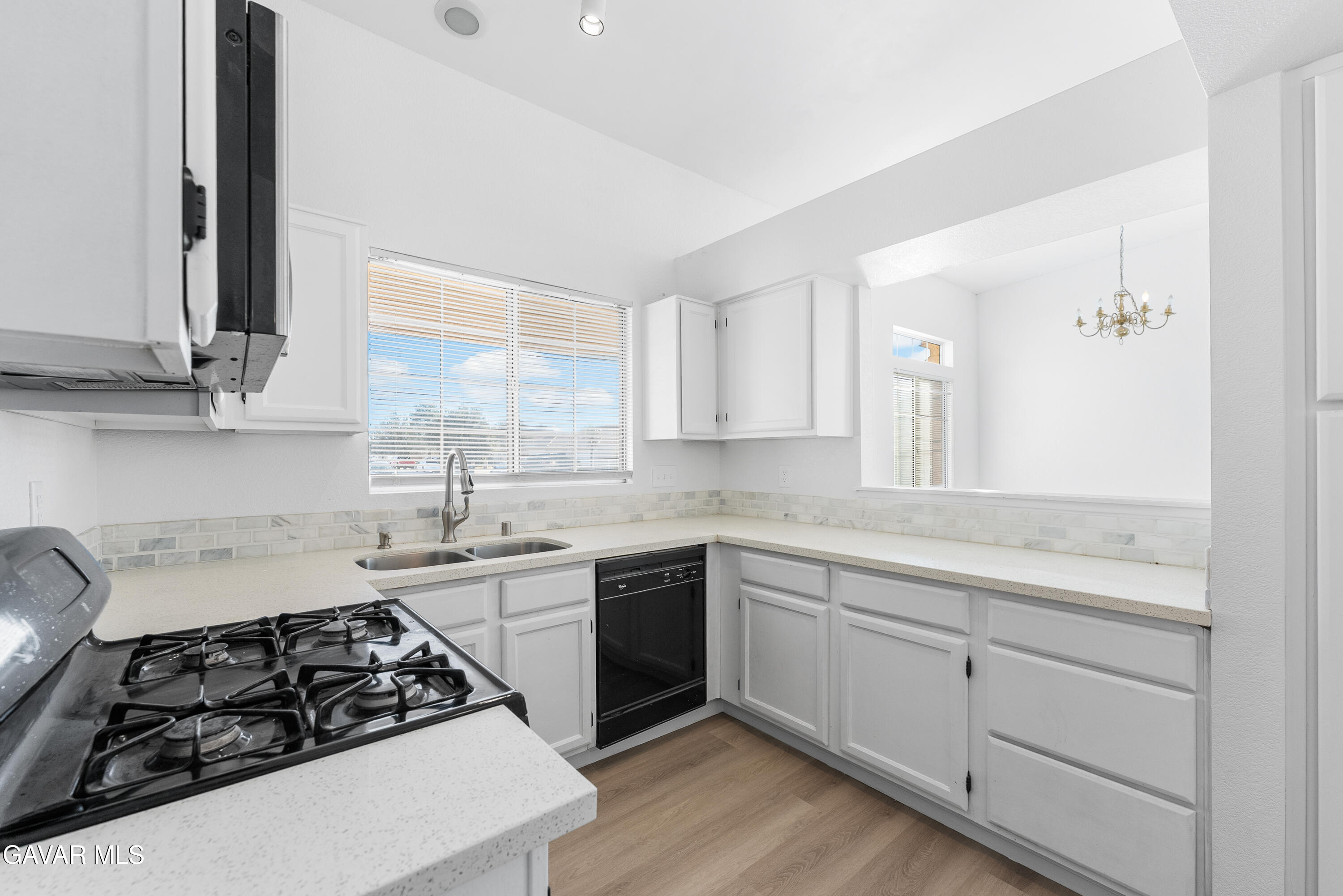 3209 Titcher Lane Rosamond, CA 93560 - Photo 8 of 36 a kitchen with white cabinets sink and stove