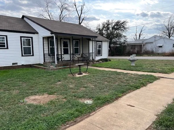 a house view with a sitting space and garden