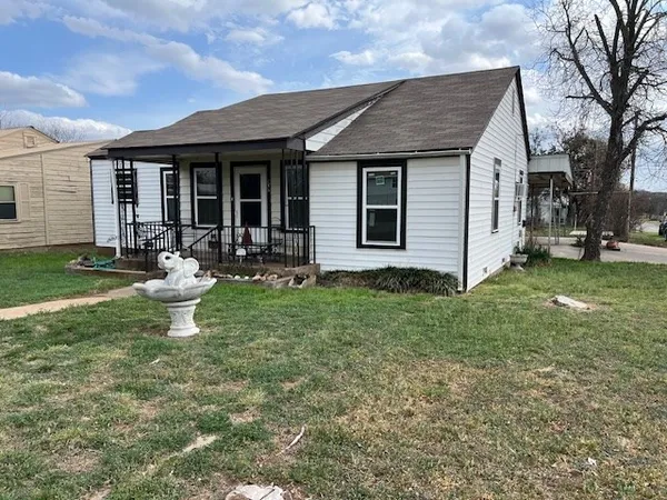 a front view of house with yard and outdoor seating