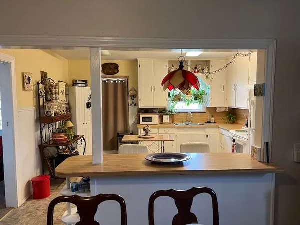 a view of dining room with furniture and chandelier