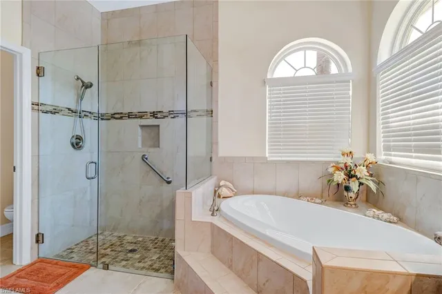 a bathroom with a granite countertop tub a sink and a shower