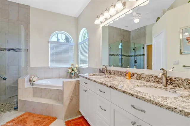 a bathroom with a tub sink and mirror