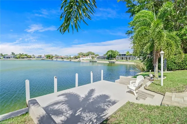 a view of a lake with a table and chairs