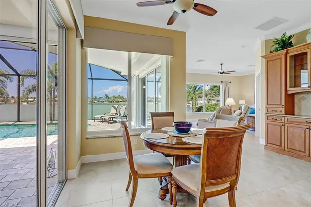 a dining room with furniture and a floor to ceiling window