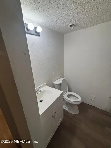 a white toilet sitting next to a white sink