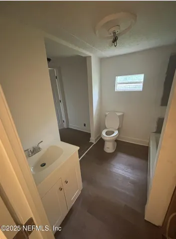 a bathroom with a toilet sink and mirror