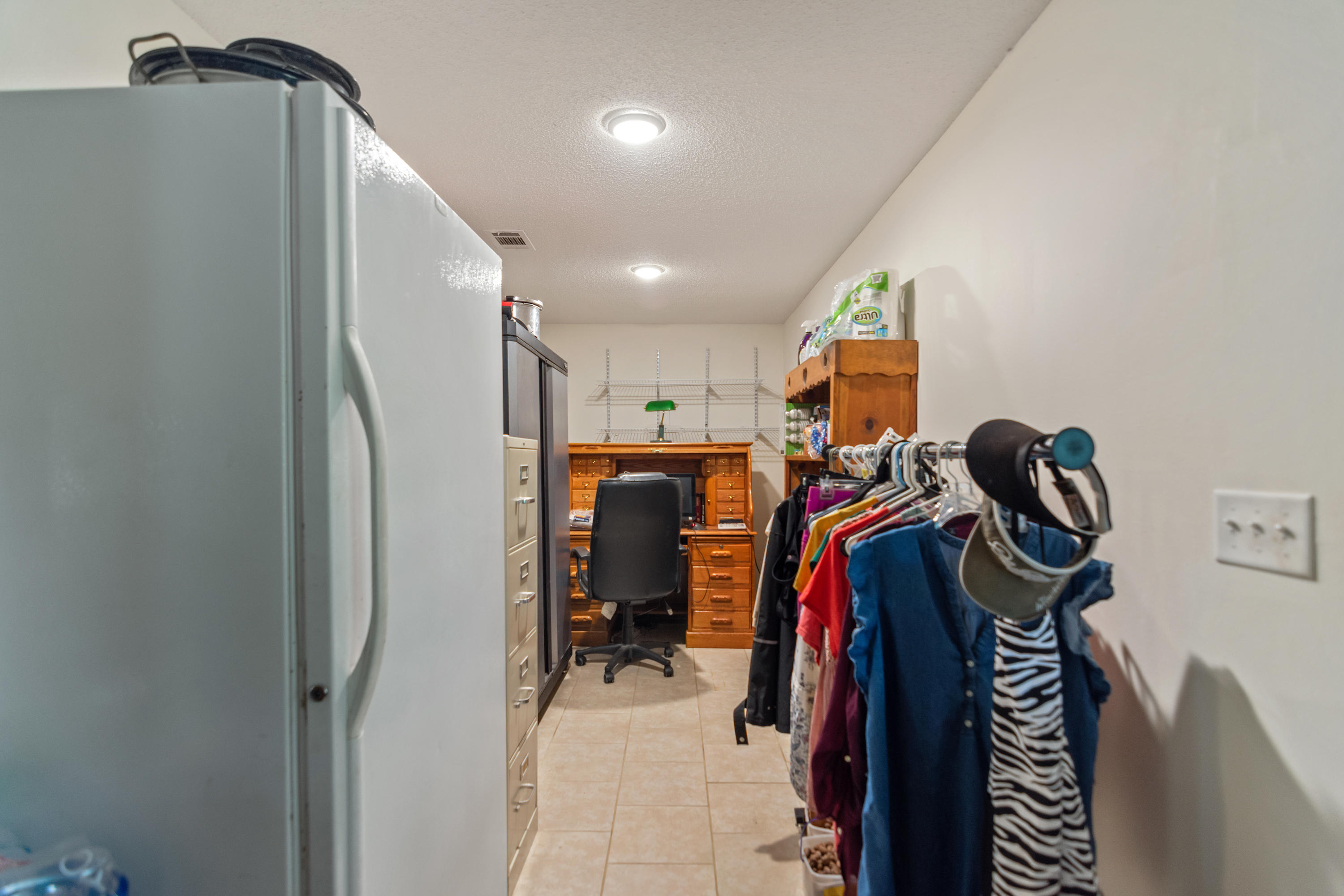 5925 Jack Stokes Road Baker, FL 32531 - Photo 11 of 15 a view of walk in closet with clothes and shoes