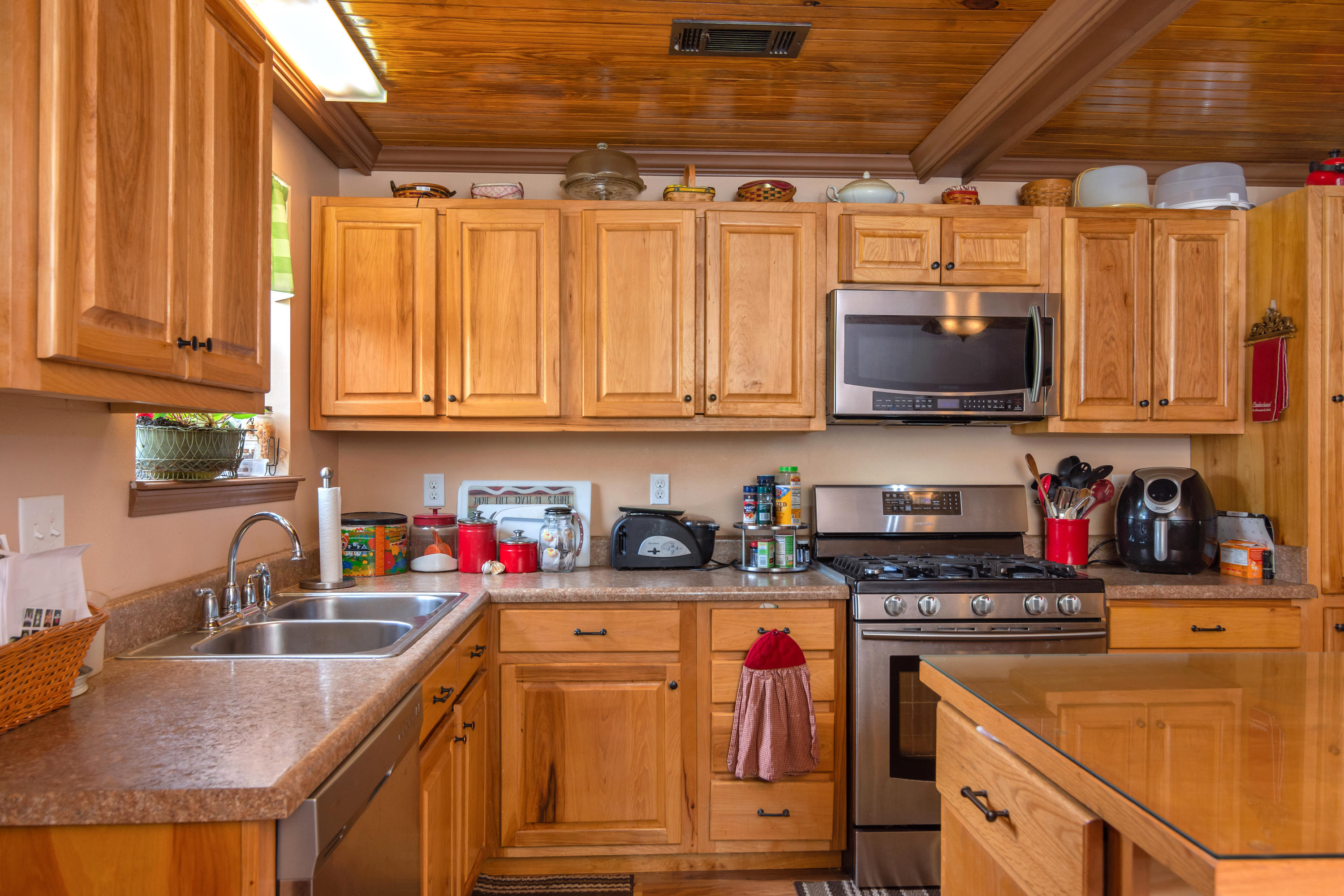5925 Jack Stokes Road Baker, FL 32531 - Photo 8 of 15 a kitchen with stainless steel appliances granite countertop a sink a stove and a microwave