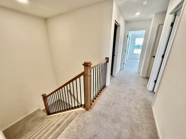 a view of a hallway with wooden floor and fence