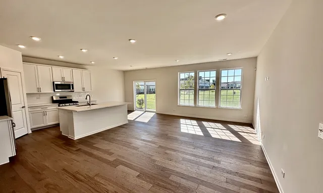 a view of kitchen with sink and wooden floor