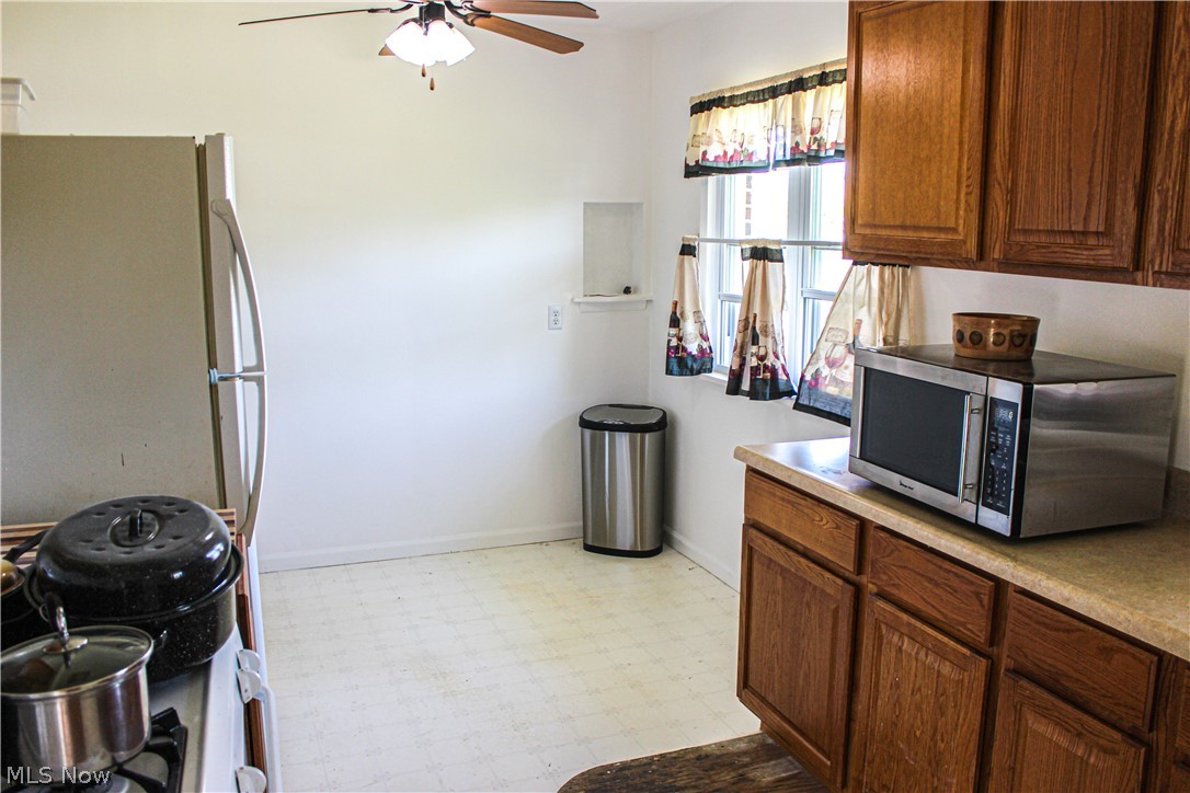 4495 Fulton Road Cleveland, OH 44144 - Photo 6 of 21 Kitchen with ceiling fan, white fridge, and light linoleum floors