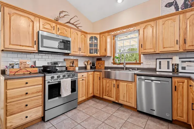 a bathroom with a sink and a mirror next to a window