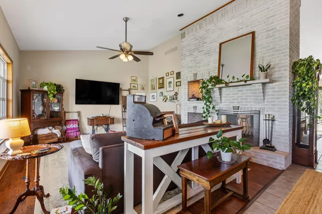 a bedroom with a bed a couch and potted plant