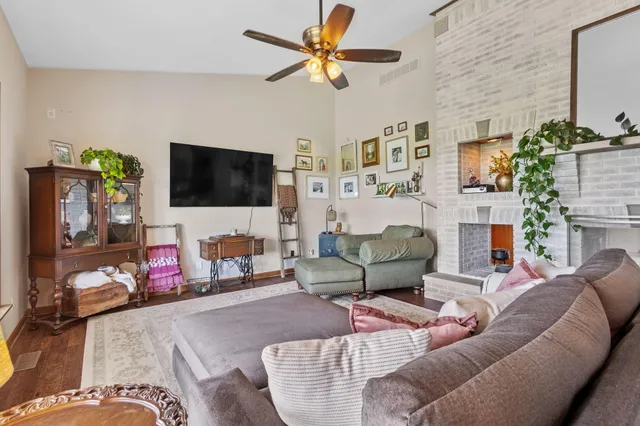 a dining hall with stainless steel appliances kitchen island granite countertop a dining table and chairs