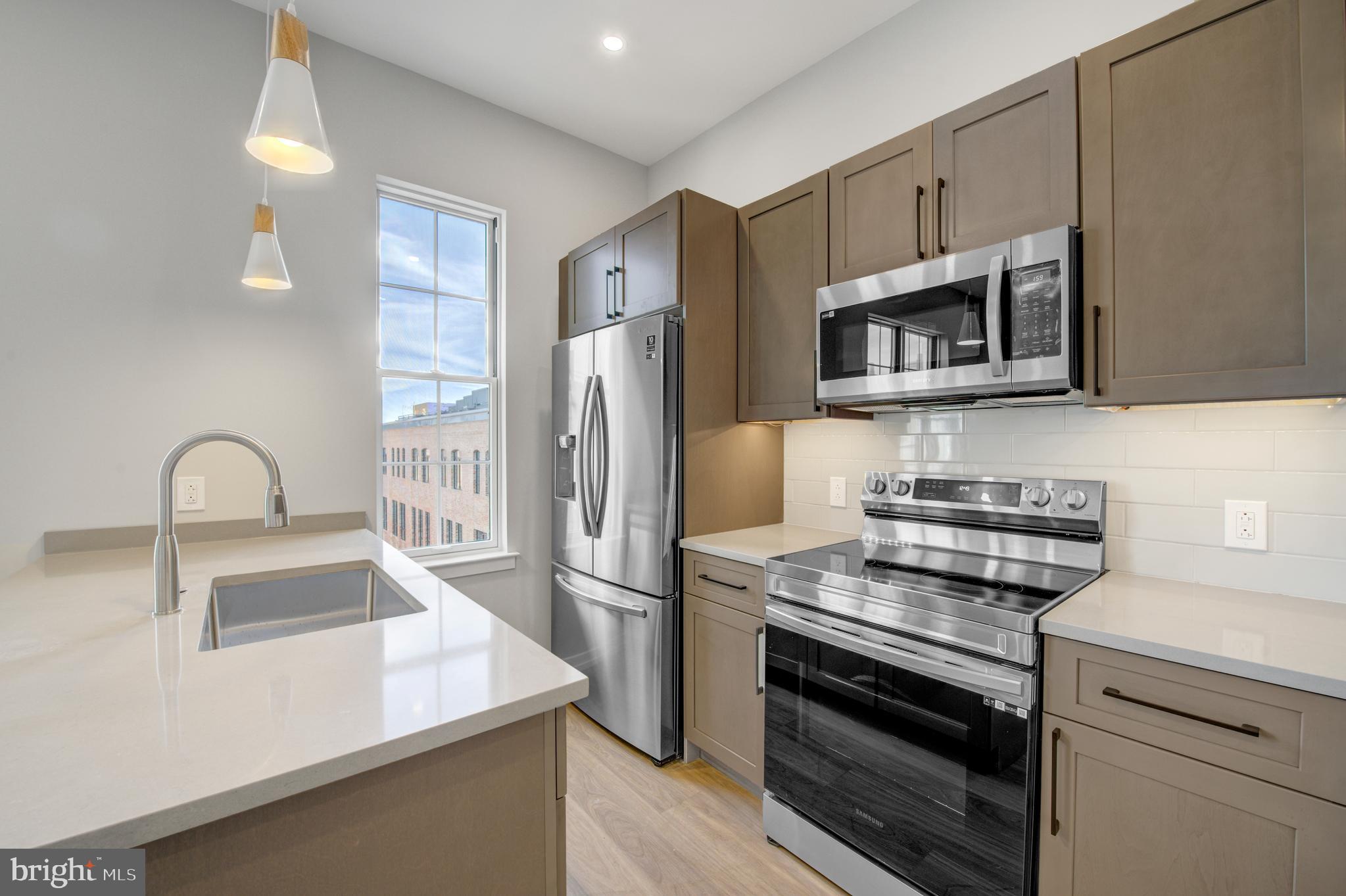 2445 Innovator Way, Unit 4I Philadelphia, PA 19146 - Photo 5 of 12 a kitchen with stainless steel appliances a refrigerator stove and microwave