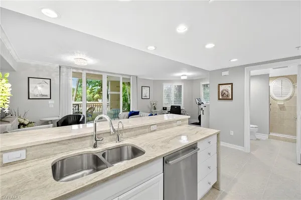 a view with a sink and livingroom with wooden floor