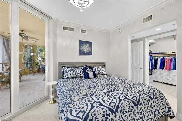 a bedroom with a large bed and a walk in closet