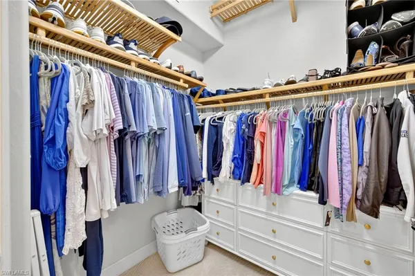 a view of walk in closet with clothes