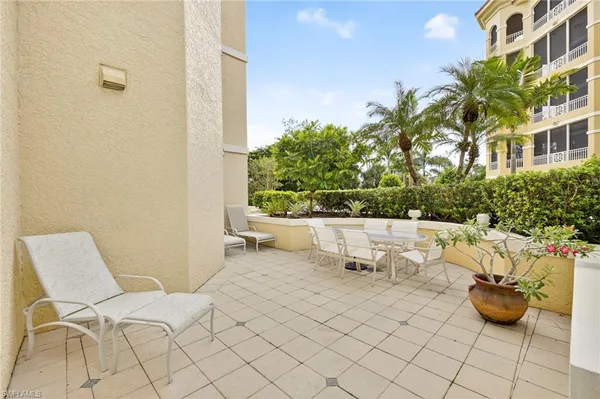 a view of a patio with couches and potted plants