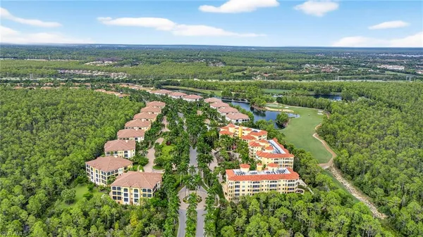 an aerial view of residential houses with outdoor space and river